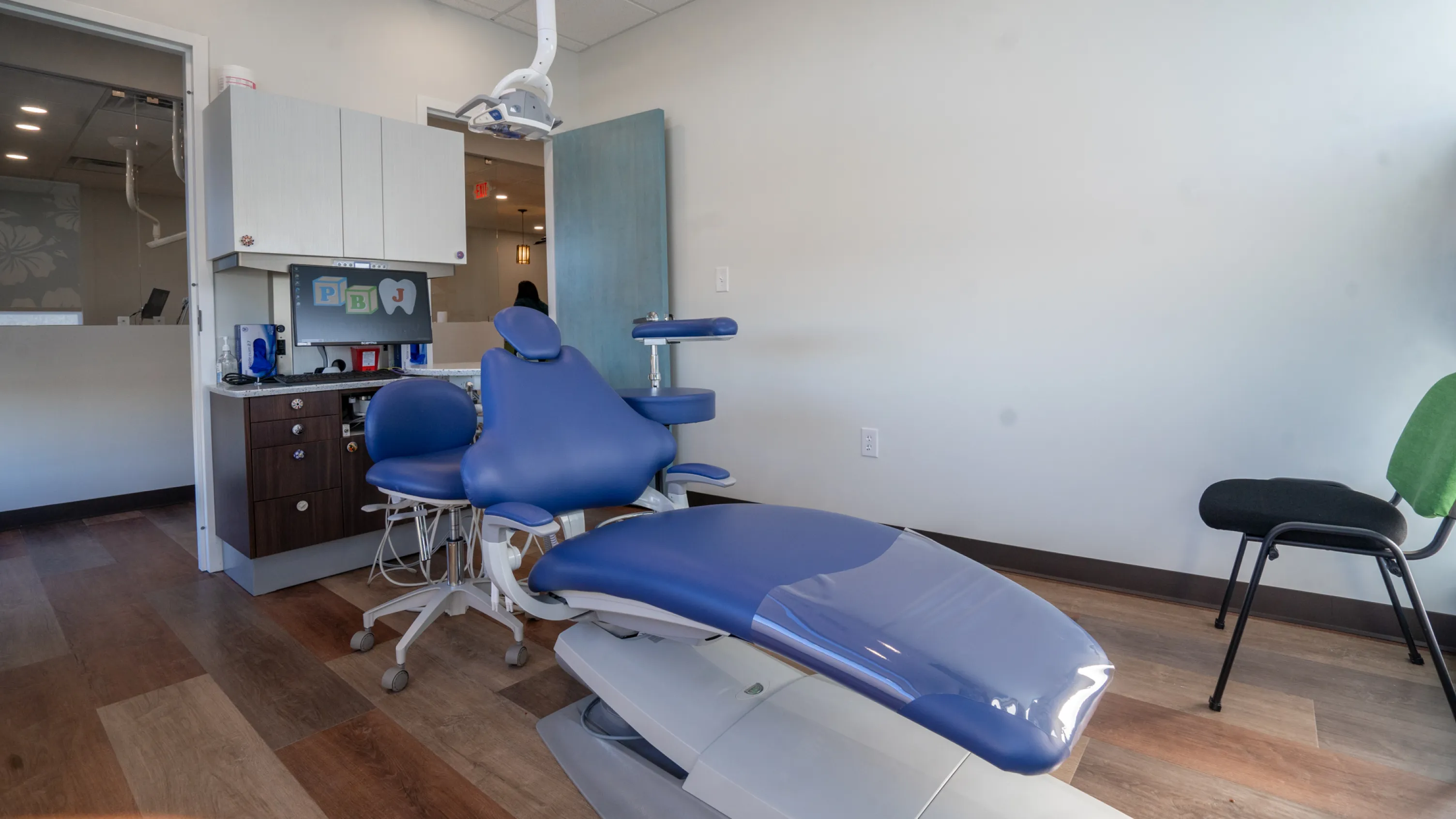 A dental room with a blue and white chair.
