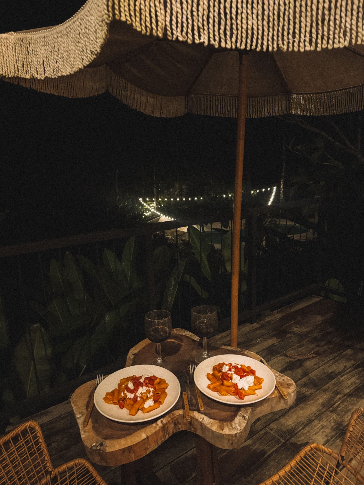Dinner for two under the umbrella on the terrace, fairy lights in the garden below