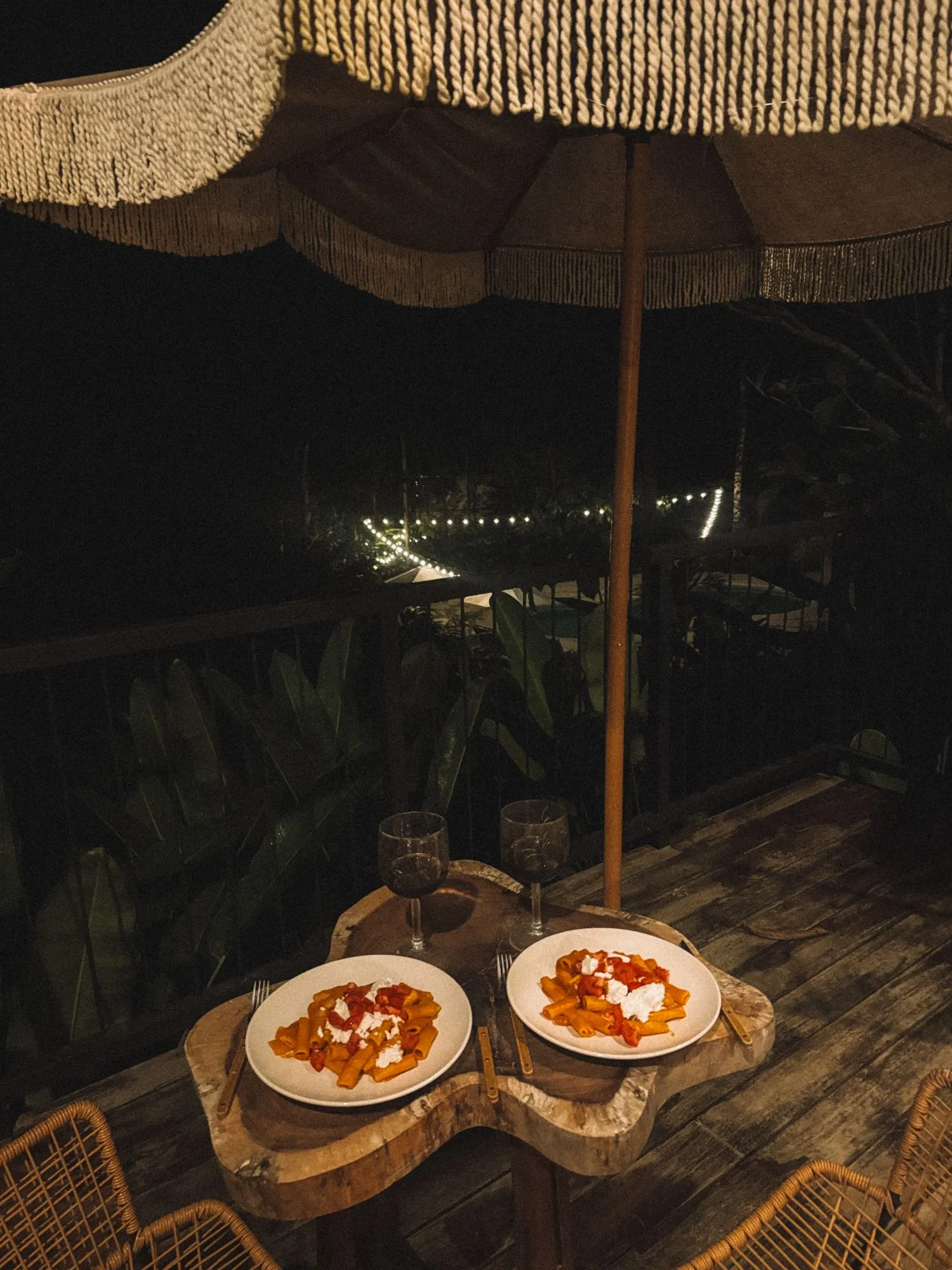 Dinner for two under the umbrella on the terrace, fairy lights in the garden below