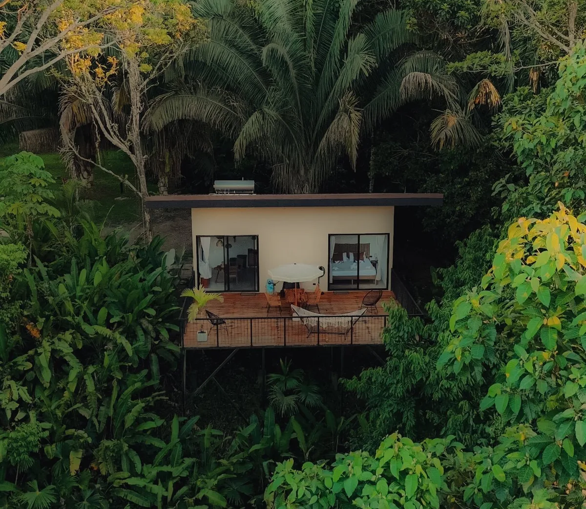 Toucan Lodge standing on stilts above the rainforest, its deck facing the valley