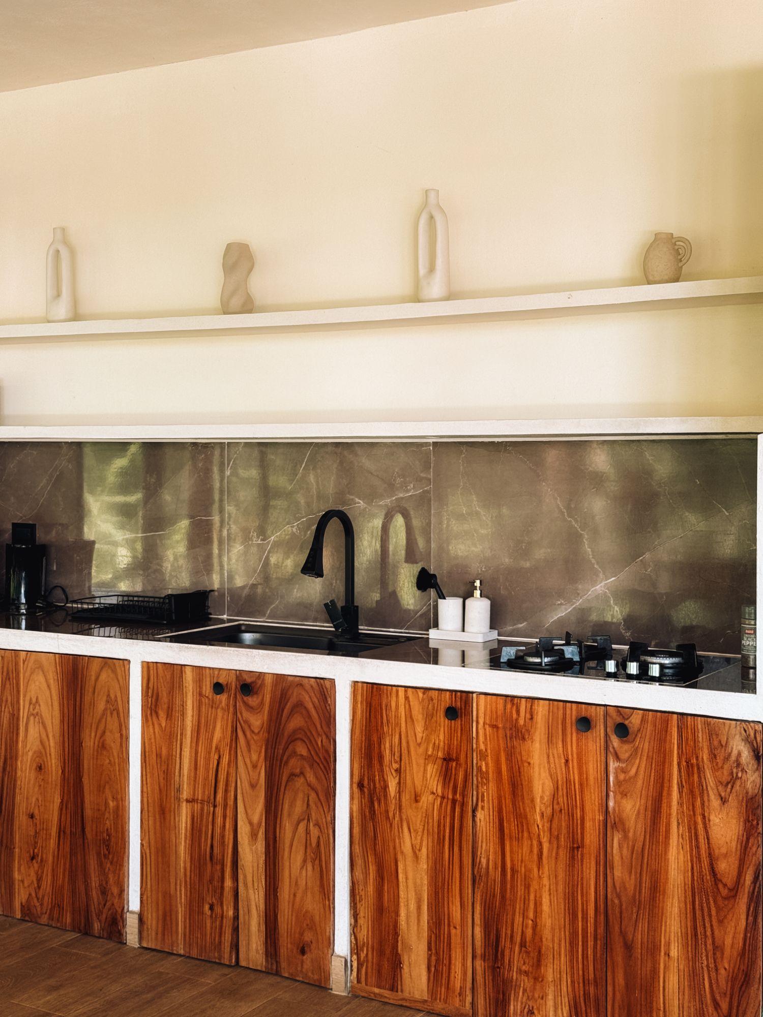 Kitchen with hand-made wooden cabinets and a marble splashback