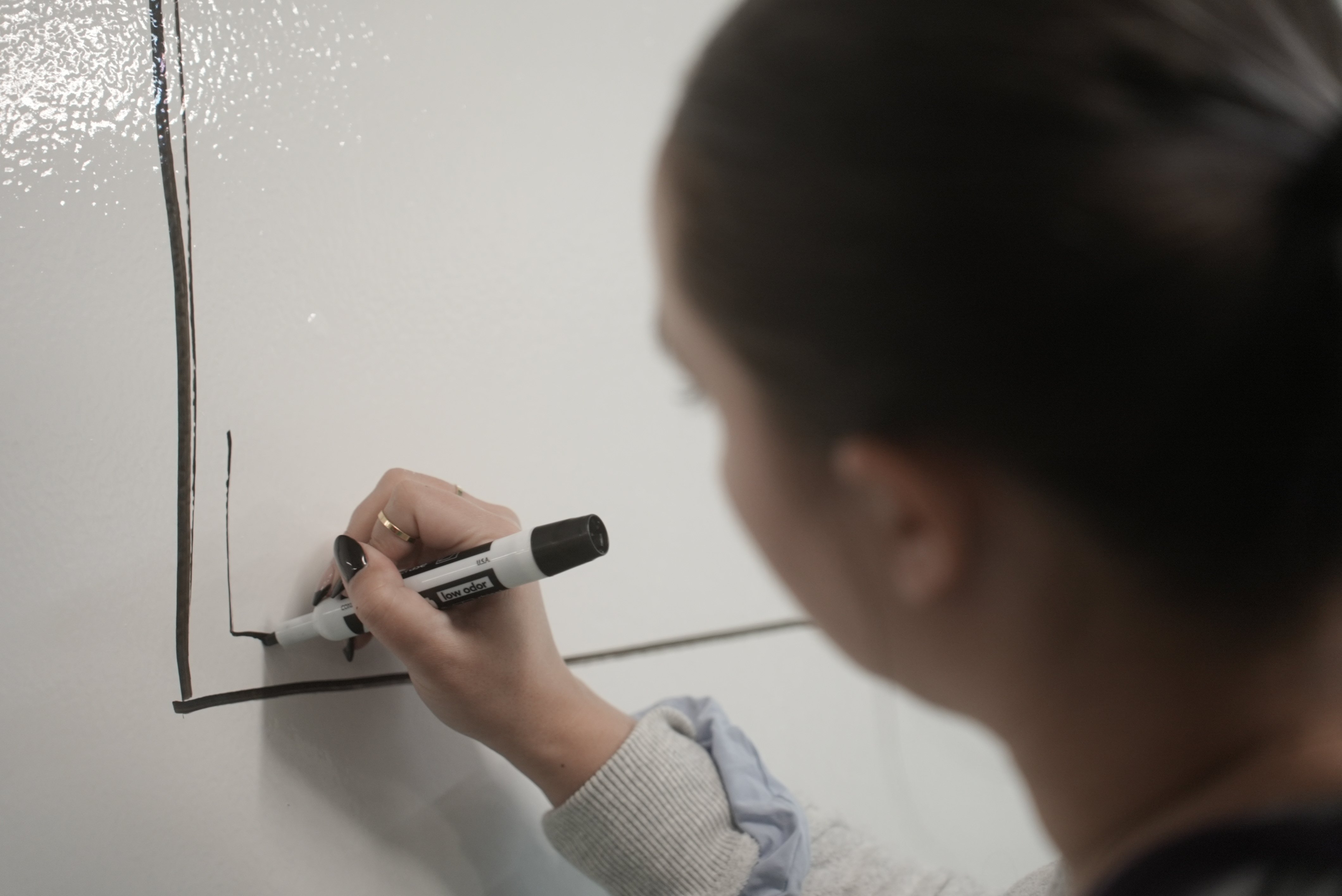Woman Writing On A Board
