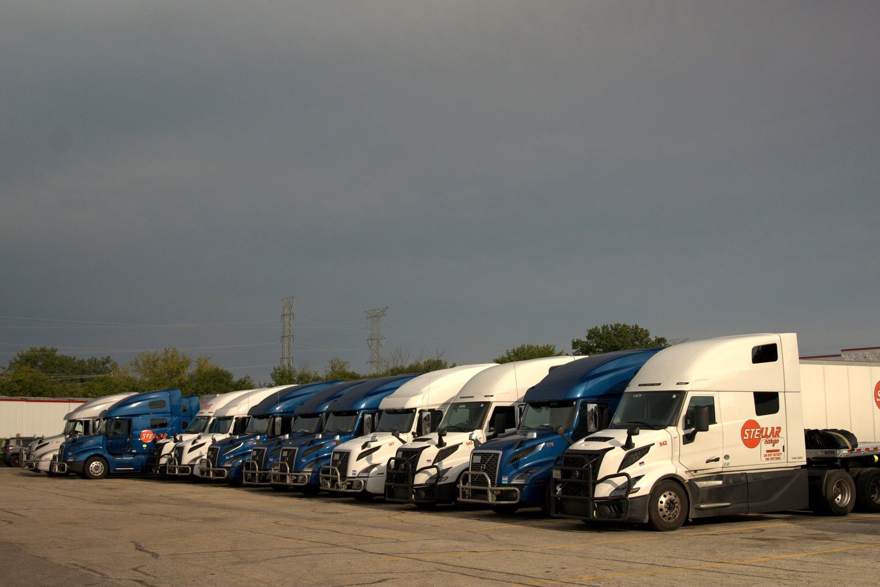 Row of Stellar Cargo trucks parked in the company yard