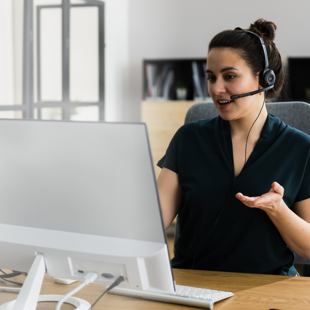 A support advisor on a headset at a desk