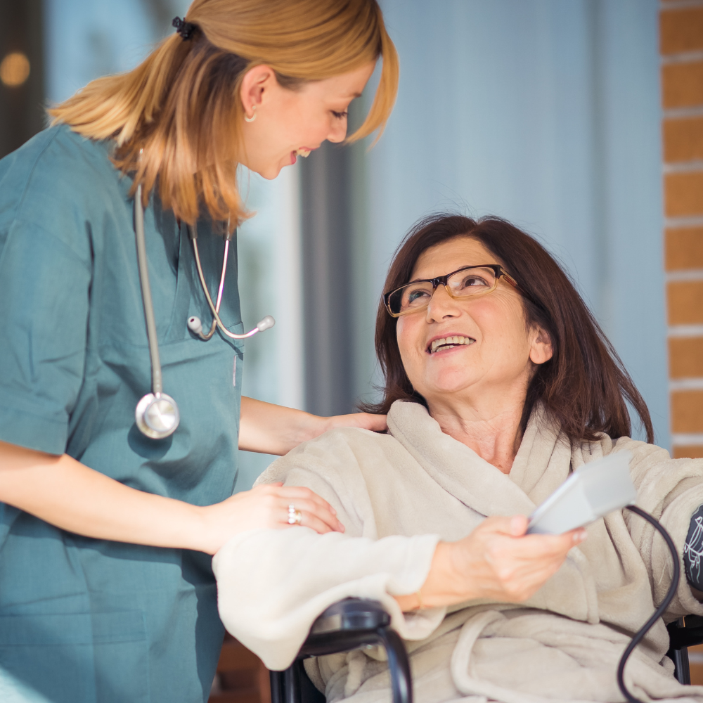 A registered nurse speaking warmly with an older woman