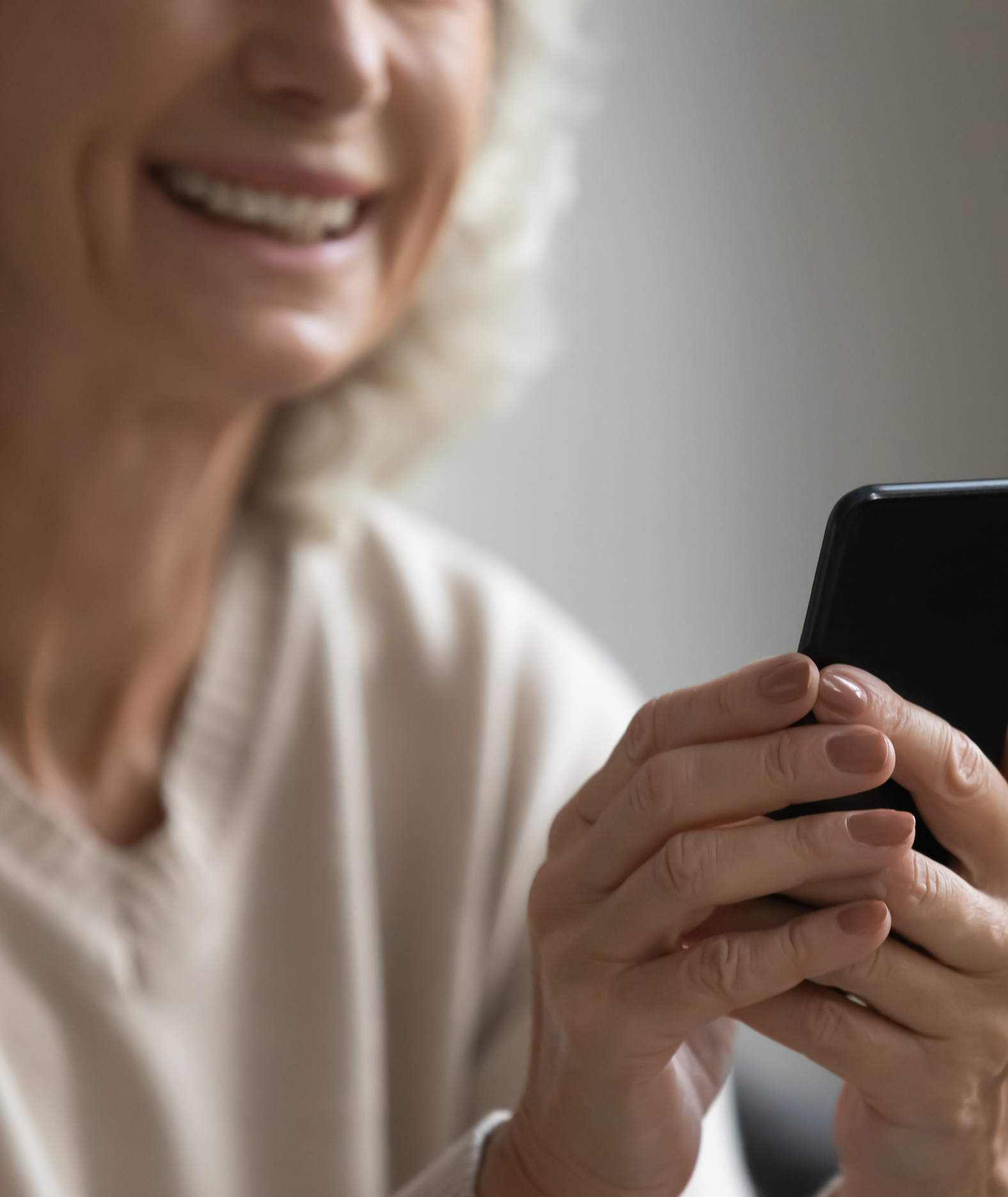 An older woman looking at her phone
