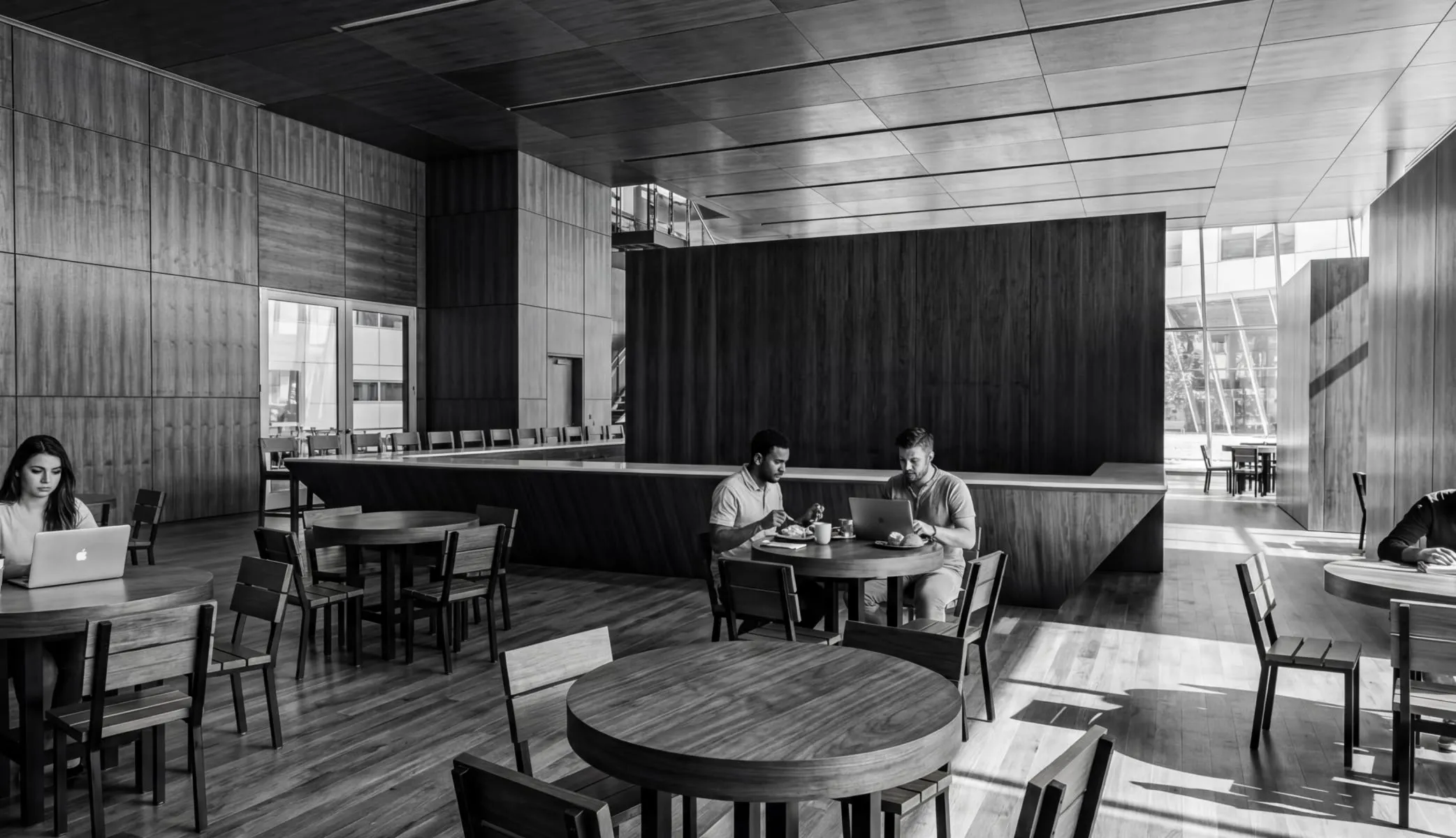 A couple of people sitting at a table in a restaurant.