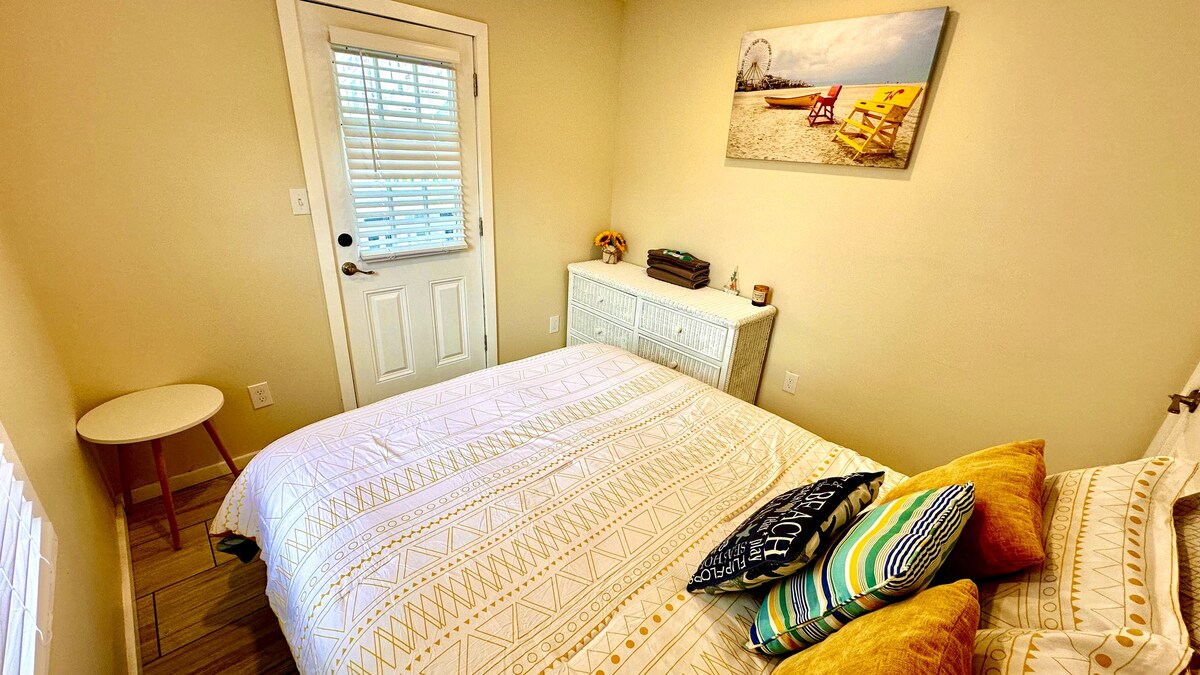Queen bed with plush comfort, featuring access to a private porch