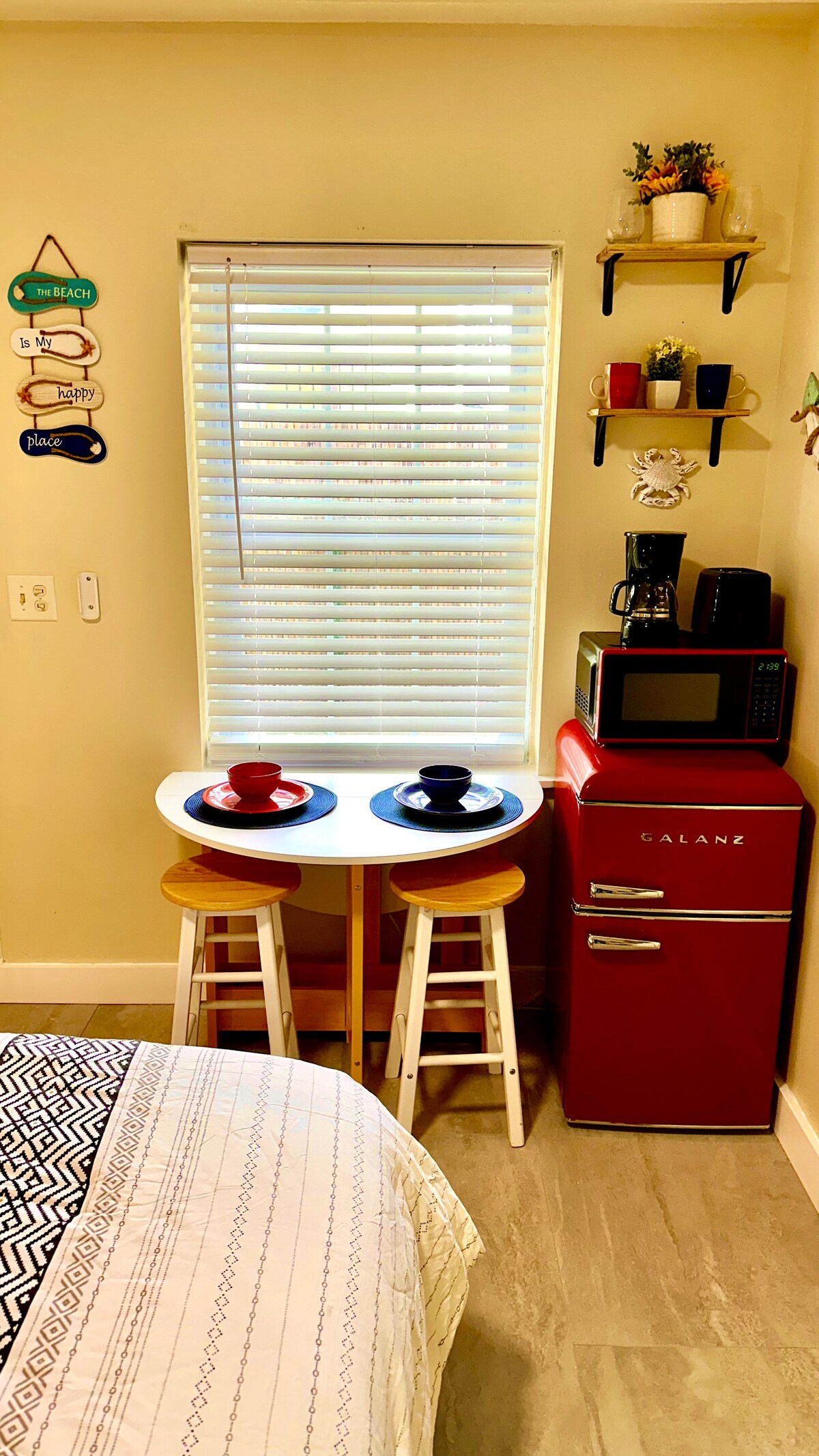 Our cozy space is thoughtfully equipped with a compact fridge, toaster, and drip coffee maker, complemented by a versati