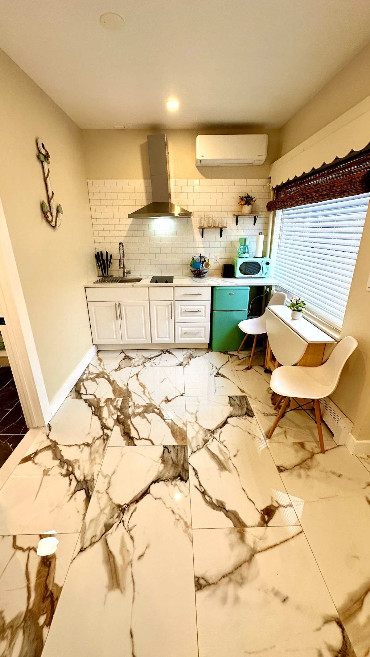 Experience the convenience of a full kitchen, complete with an electric cooktop and a foldable dining table