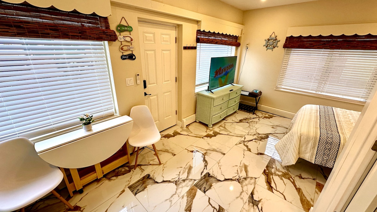 Experience the convenience of a full kitchen, complete with an electric cooktop and a foldable dining table