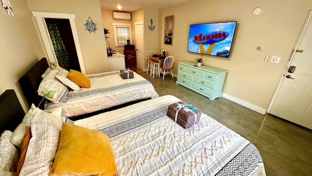 Indulge in the luxury Queen beds and the excitement of a 65-inch TV for the perfect blend of comfort and entertainment i
