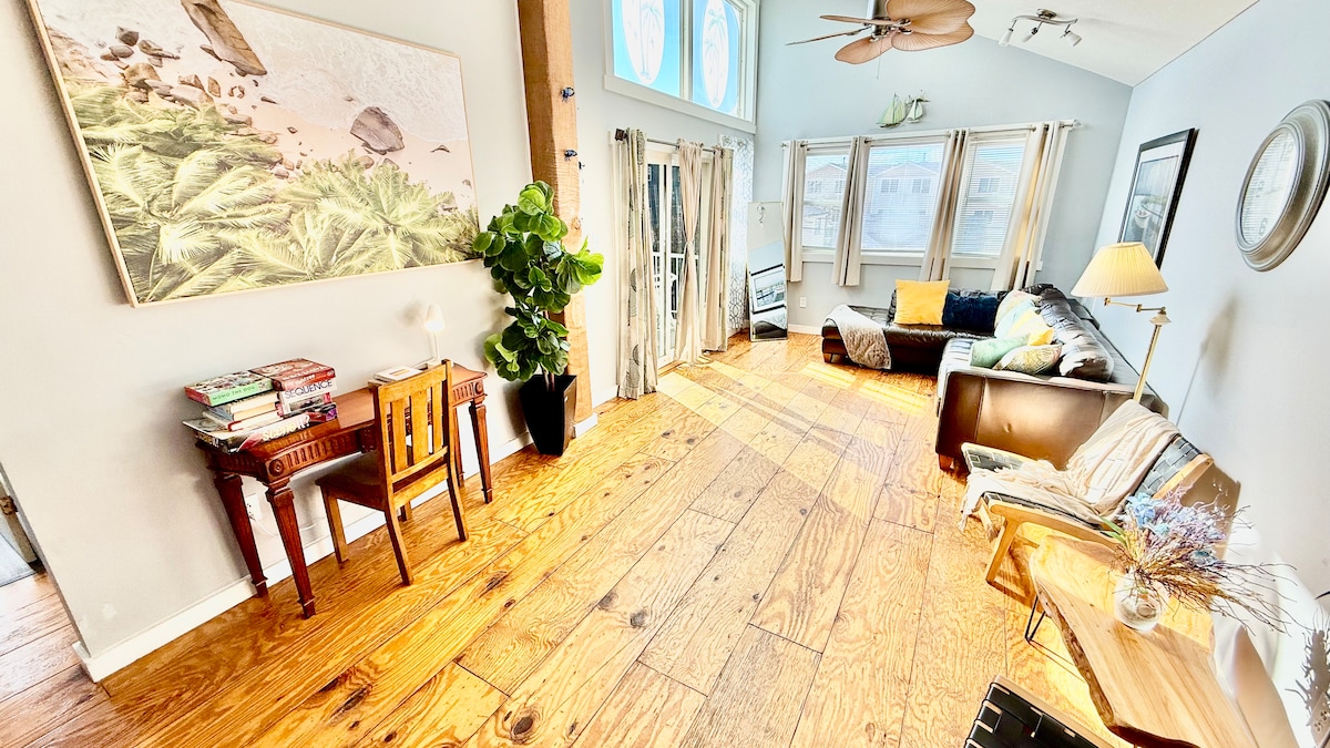 Second-floor living room with Italian leather sofa and access to a top deck featuring ocean views—perfect for morning co