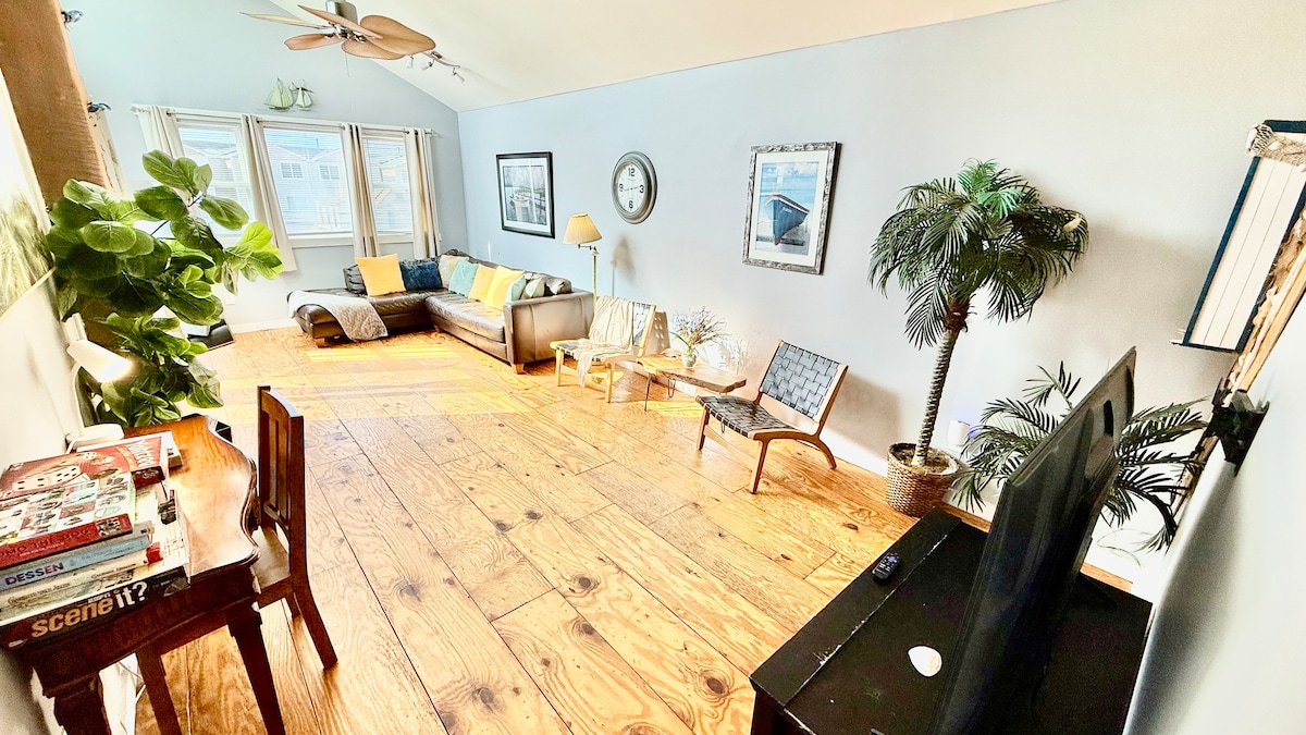 Second-floor living room with Italian leather sofa and access to a top deck featuring ocean views—perfect for morning co