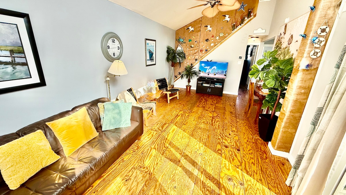 Second-floor living room with Italian leather sofa and access to a top deck featuring ocean views—perfect for morning co