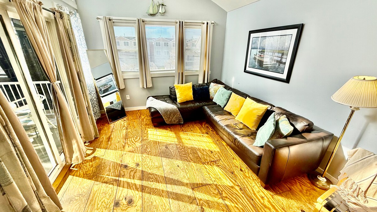 Second-floor living room with Italian leather sofa and access to a top deck featuring ocean views—perfect for morning co