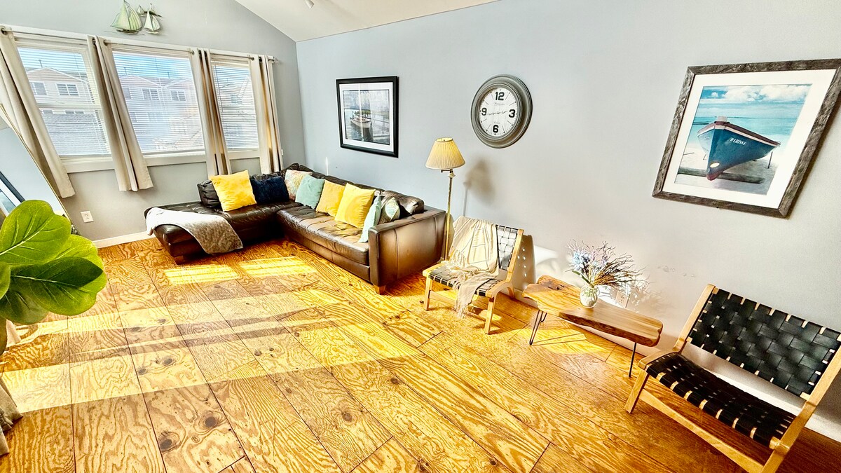 Second-floor living room with Italian leather sofa and access to a top deck featuring ocean views—perfect for morning co