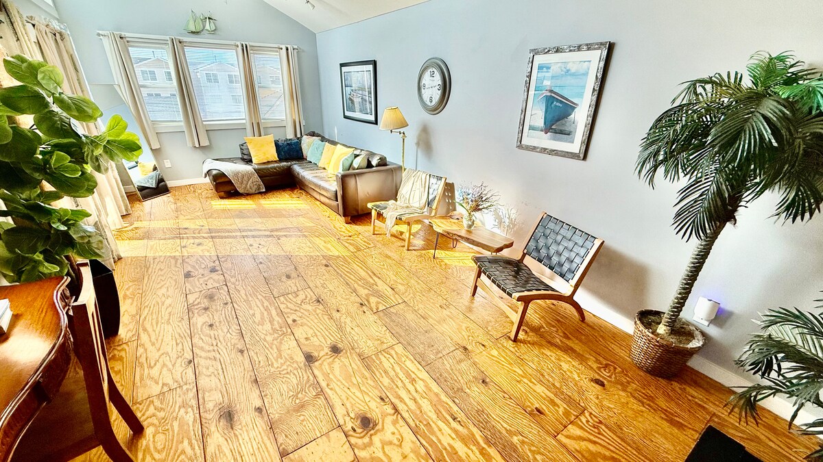 Second-floor living room with Italian leather sofa and access to a top deck featuring ocean views—perfect for morning co