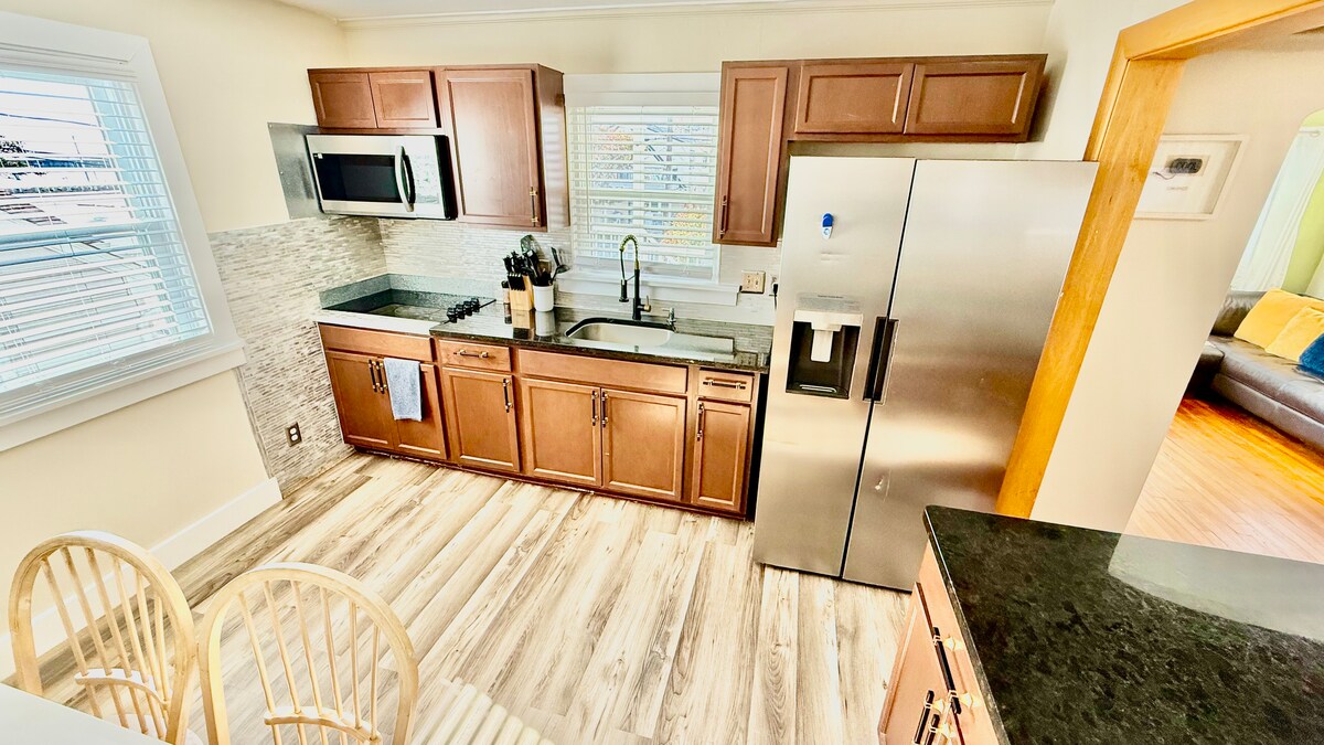 Full kitchen with a dining table, large additional dining area, and a breakfast bar—plenty of seating for everyone to ga