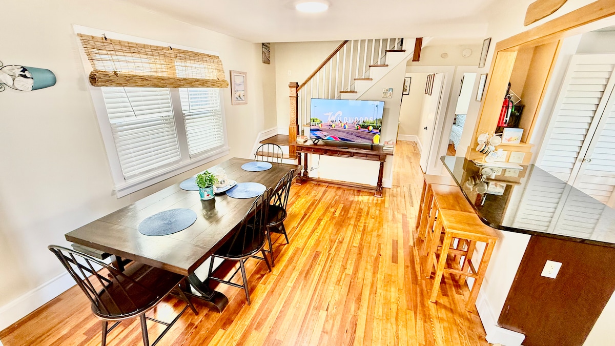 Dining area with a large table and breakfast bar—plenty of space for everyone to sit together and enjoy meals and good t