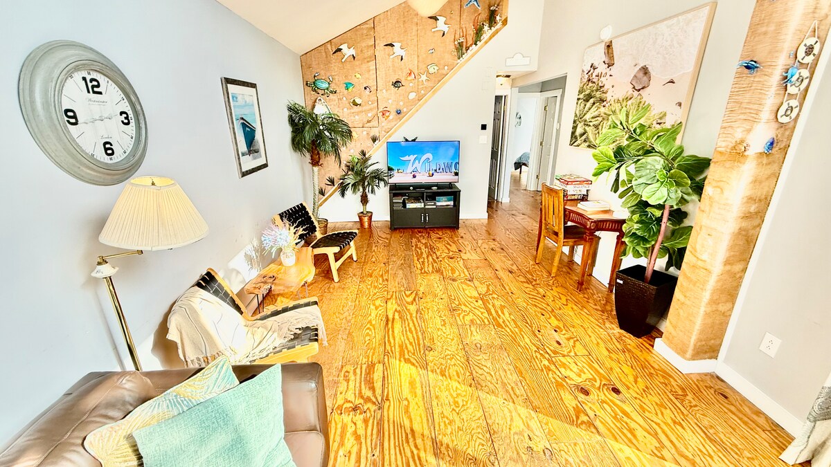 Second-floor living room with Italian leather sofa and access to a top deck featuring ocean views—perfect for morning co