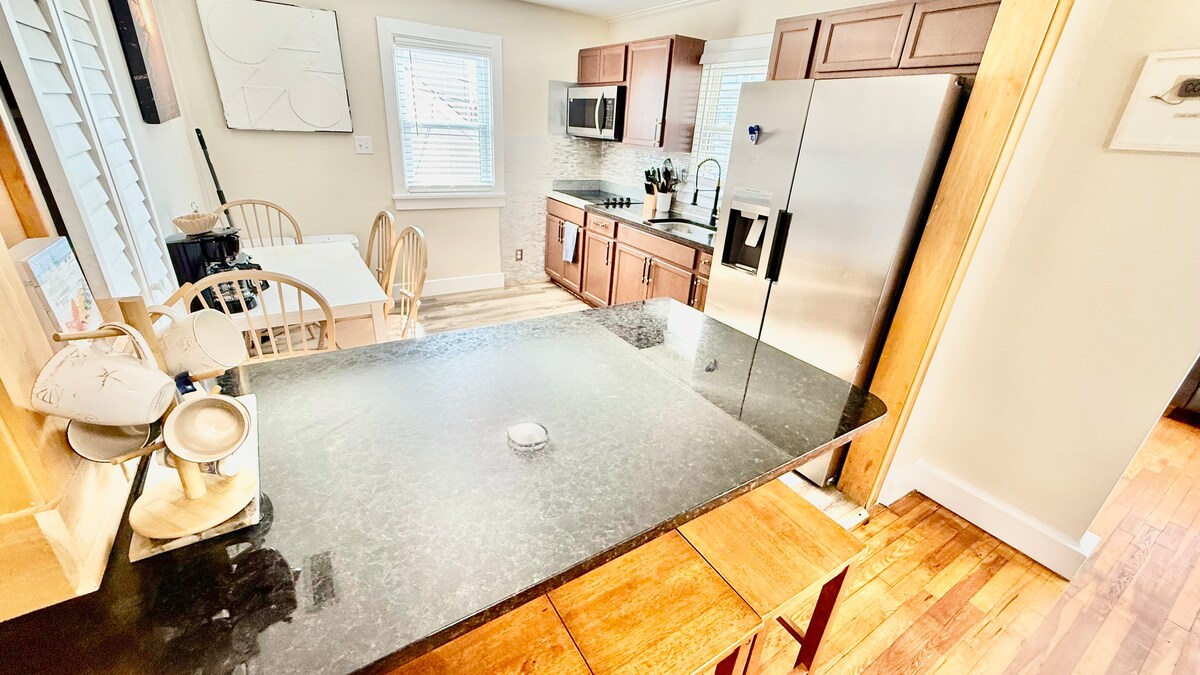 Full kitchen with a dining table, large additional dining area, and a breakfast bar—plenty of seating for everyone to ga