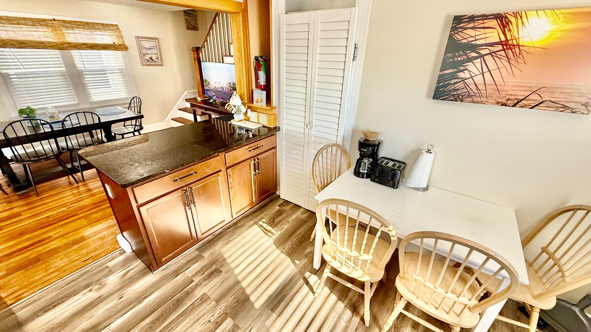 Full kitchen with a dining table, large additional dining area, and a breakfast bar—plenty of seating for everyone to ga
