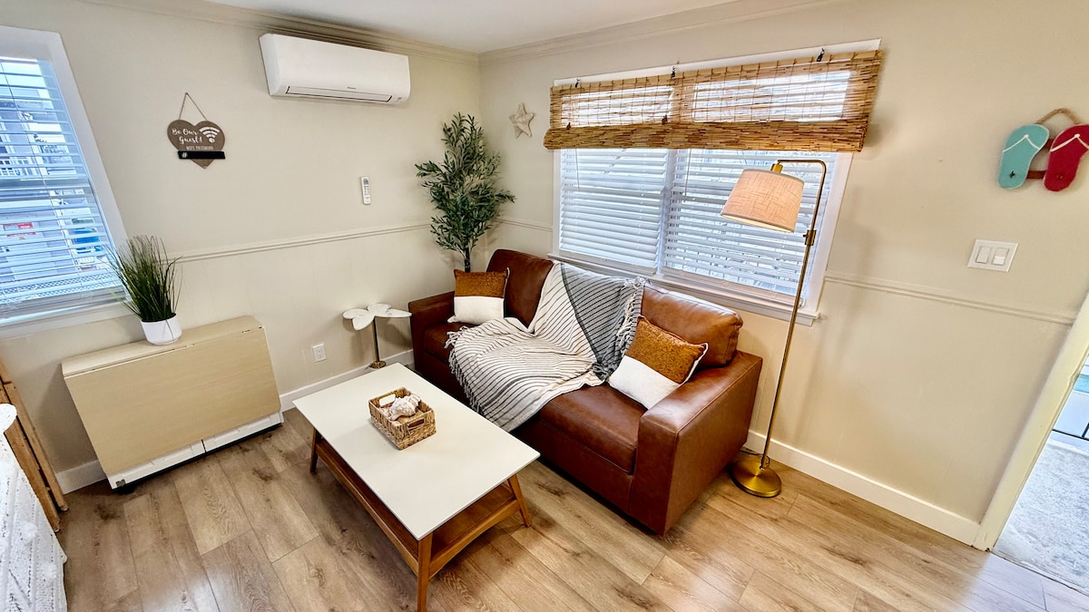 Bright and functional living area with a full kitchen, folding dining table, and a pull-out queen sofa. Every detail fol