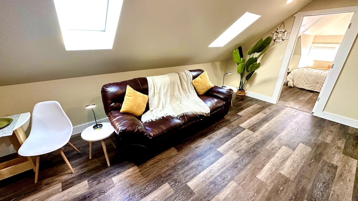 Enjoy luxury and comfort in our bright living room, boasting a cozy couch, 65-inch TV, and large sky windows that fill t