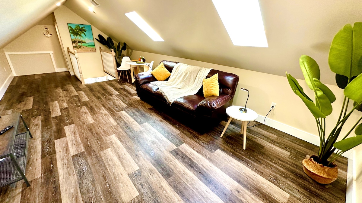 Enjoy luxury and comfort in our bright living room, boasting a cozy couch, 65-inch TV, and large sky windows that fill t
