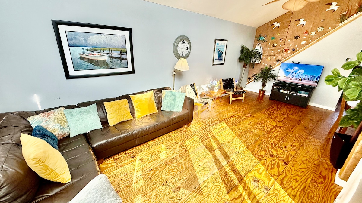 Second-floor living room with Italian leather sofa and access to a top deck featuring ocean views—perfect for morning co