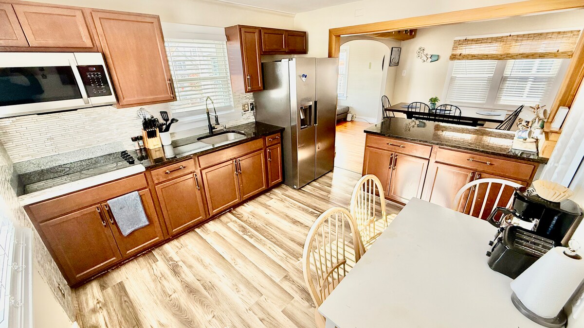 Full kitchen with a dining table, large additional dining area, and a breakfast bar—plenty of seating for everyone to ga