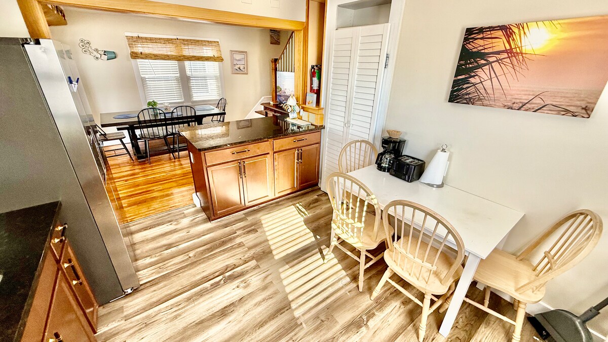 Full kitchen with a dining table, large additional dining area, and a breakfast bar—plenty of seating for everyone to ga