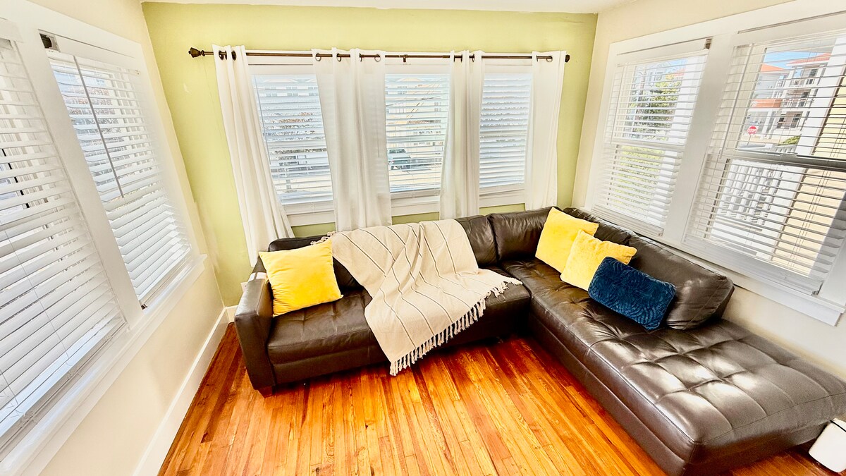 Entrance on the first floor into an open-space living room with dining area and a stylish Italian leather sofa.