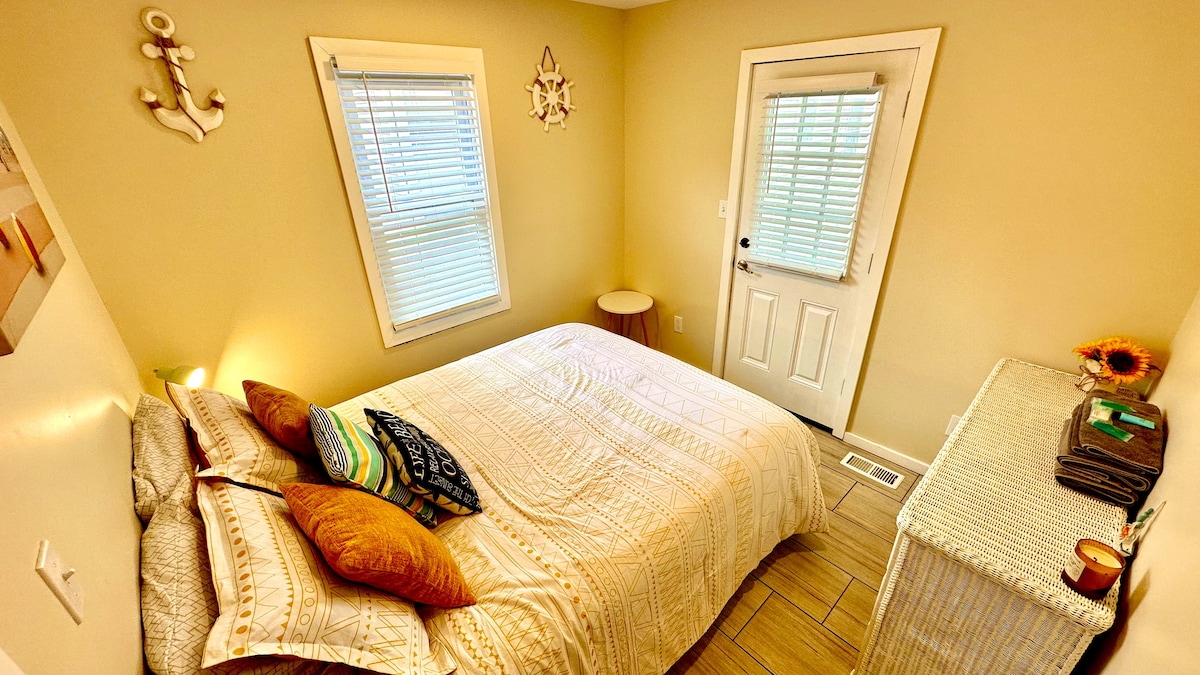 Queen bed with plush comfort, featuring access to a private porch