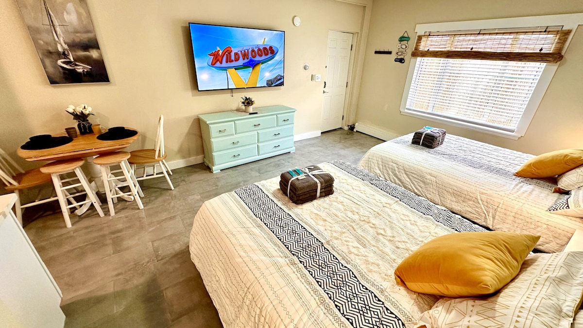 Indulge in the luxury Queen beds and the excitement of a 65-inch TV for the perfect blend of comfort and entertainment i