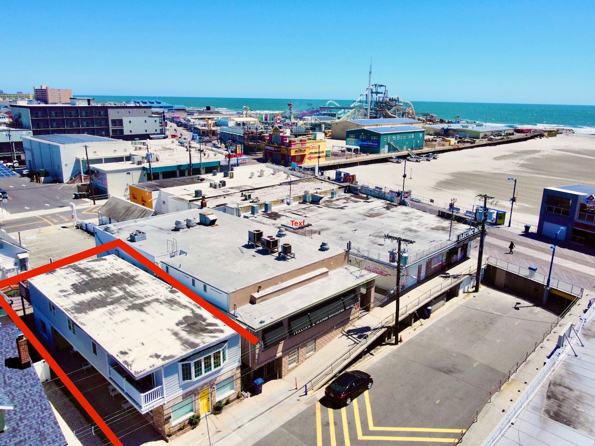 Aerial shot of the house near the beach and boardwalk