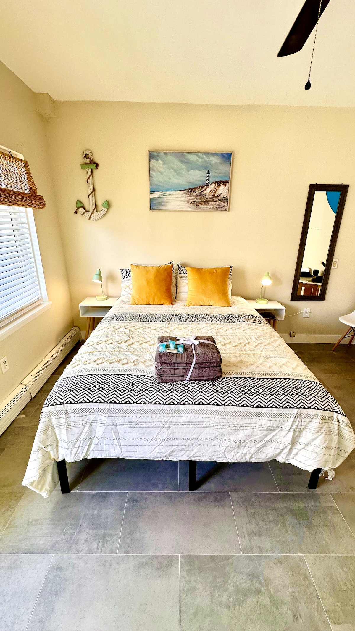 Our queen-size bed, cocooned in luxuriously soft bedsheets for a restful night's sleep. Dive into relaxation and wake up