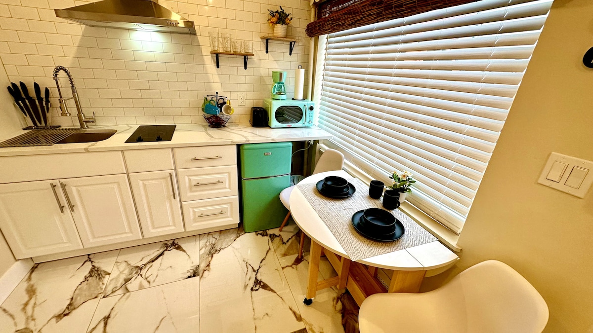 Experience the convenience of a full kitchen, complete with an electric cooktop and a foldable dining table