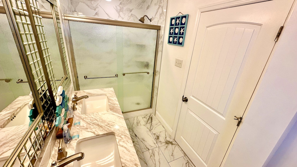 Spa-like Retreat: Luxurious Full Bathroom featuring Double Vanity and Expansive Shower