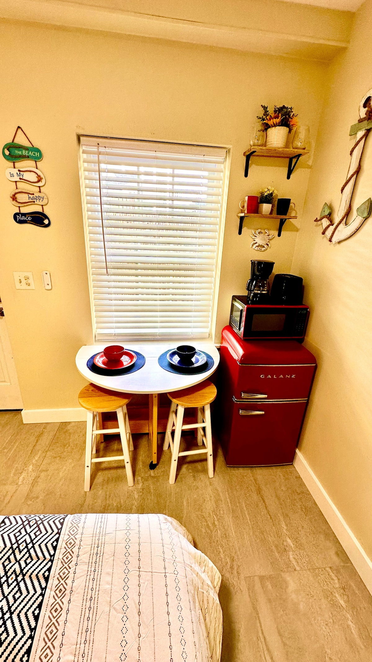 Our cozy space is thoughtfully equipped with a compact fridge, toaster, and drip coffee maker, complemented by a versati