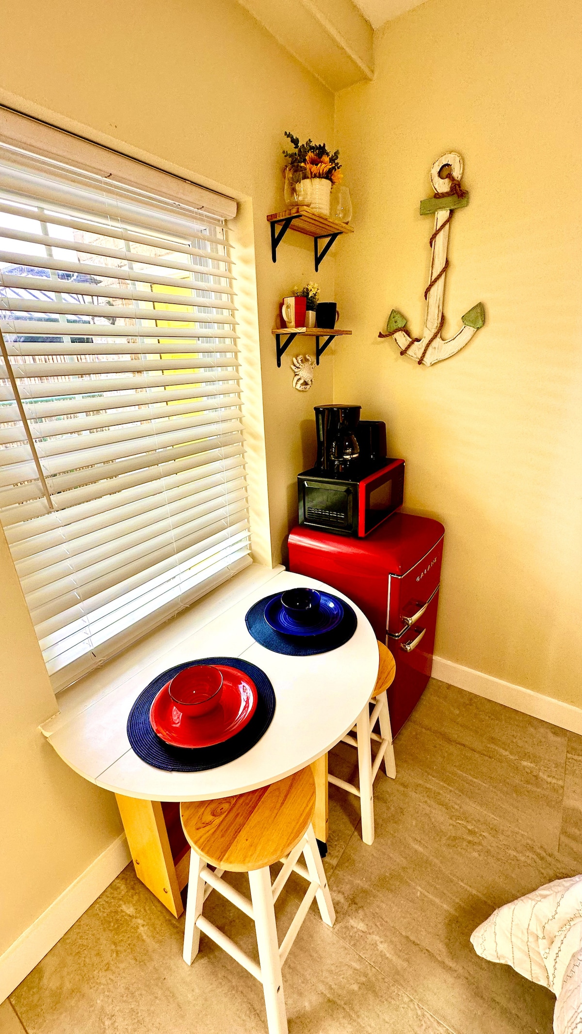 Our cozy space is thoughtfully equipped with a compact fridge, toaster, and drip coffee maker, complemented by a versati