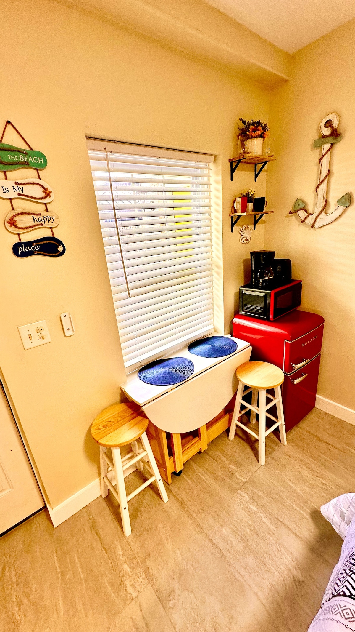 Our cozy space is thoughtfully equipped with a compact fridge, toaster, and drip coffee maker, complemented by a versati