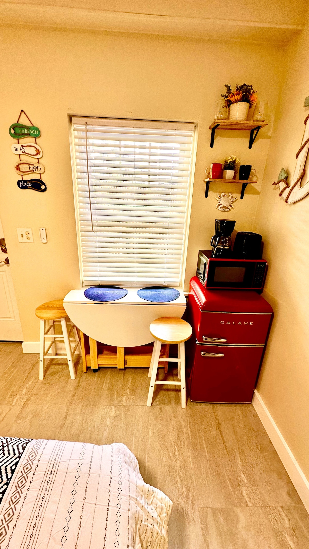 Our cozy space is thoughtfully equipped with a compact fridge, toaster, and drip coffee maker, complemented by a versati