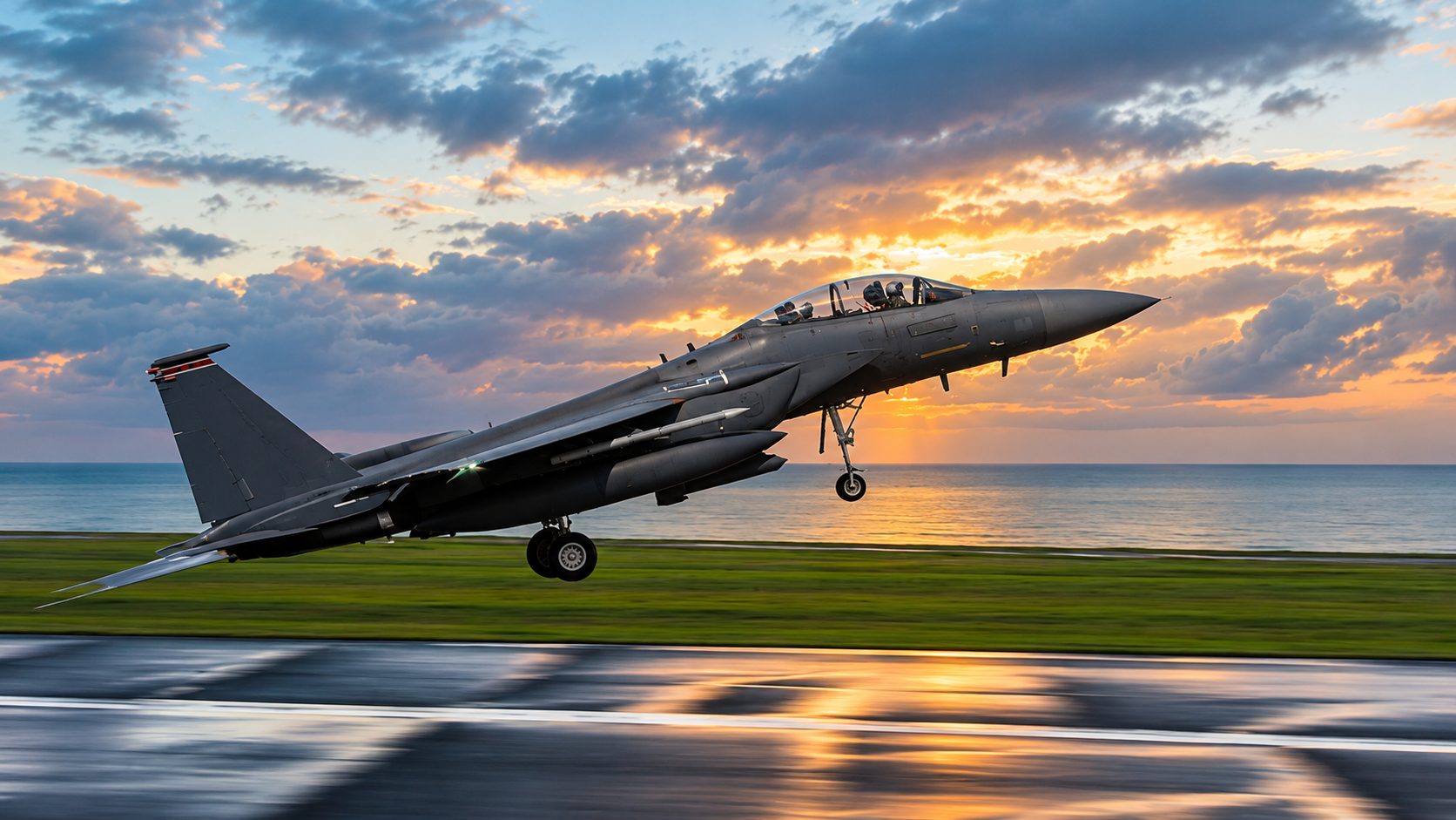 Dark gray fighter jet taking off from a wet runway at sunset with landing gear extended and dramatic clouds over the ocean.