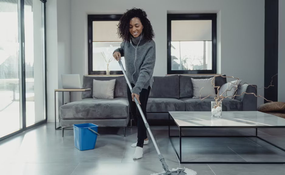 Office cleaner tidying a bright workspace