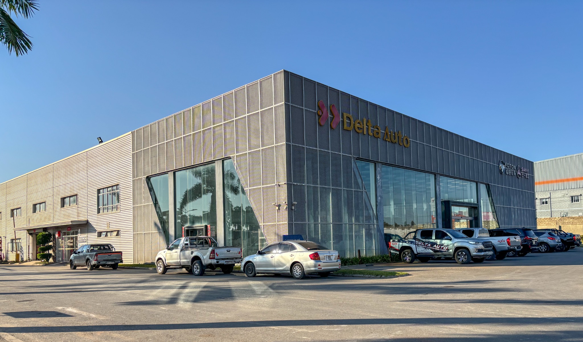 Delta Auto office and showroom exterior with vehicles parked outside