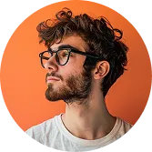 Profile portrait of a young man with curly hair, beard, glasses, and a white shirt on an orange background.