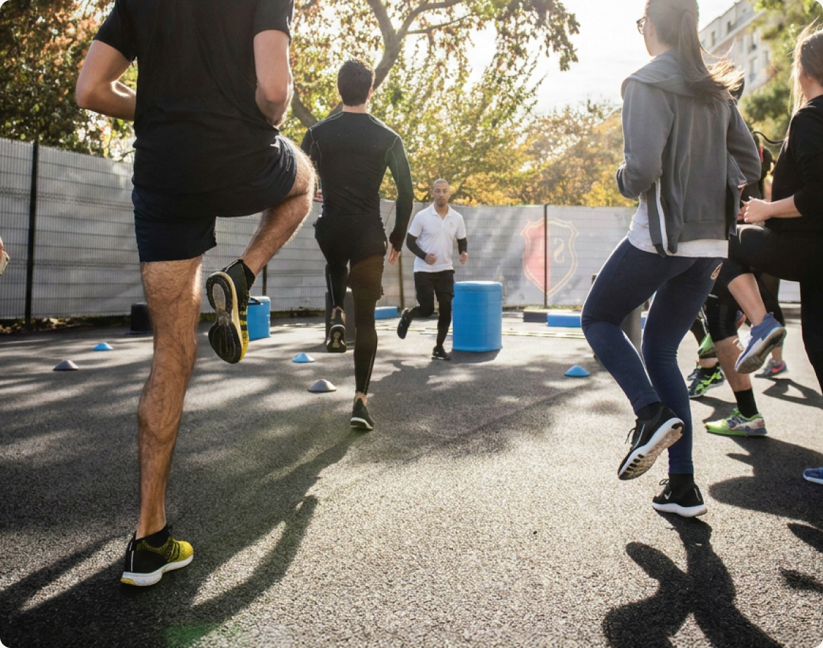 A small group training session running outdoors in a park