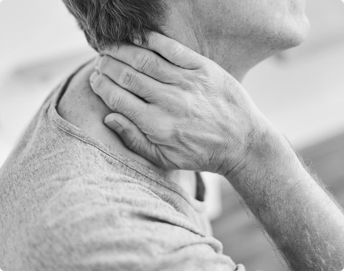 A person holding the back of their neck where it hurts